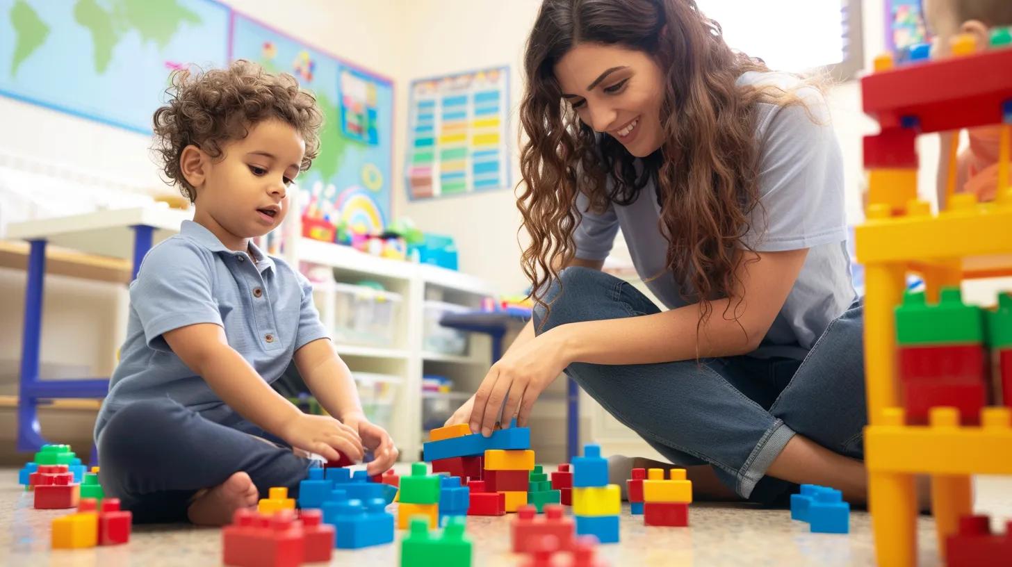 An occupational therapist sitting on the floor with a child, playing with colorful blocks