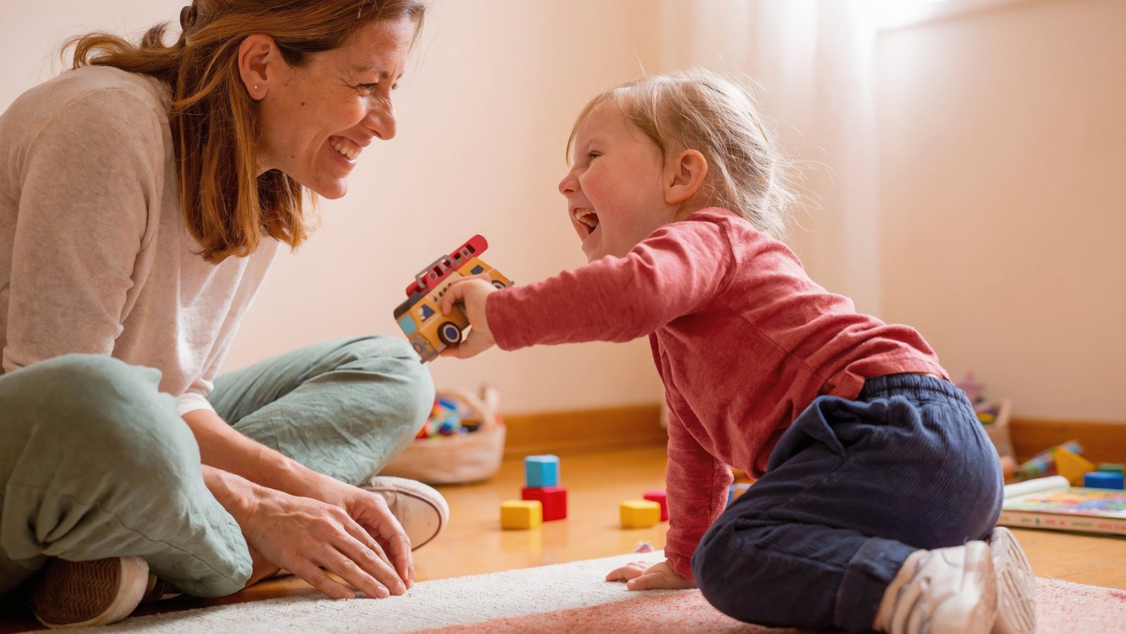Pediatric therapist playing with a child during a session